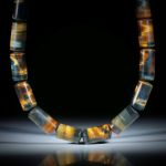 Edelsteincollier Tiger- / Falkenauge, polierte Zylinderformen mit bombierten Seiten, Durchmesser 12mm, Länge ca.46cm