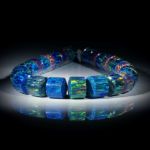 Collier aus synthetischem Opal, Zylinderformen mit bombierten Seiten, Durchmesser 15-18mm, Länge ca.45cm